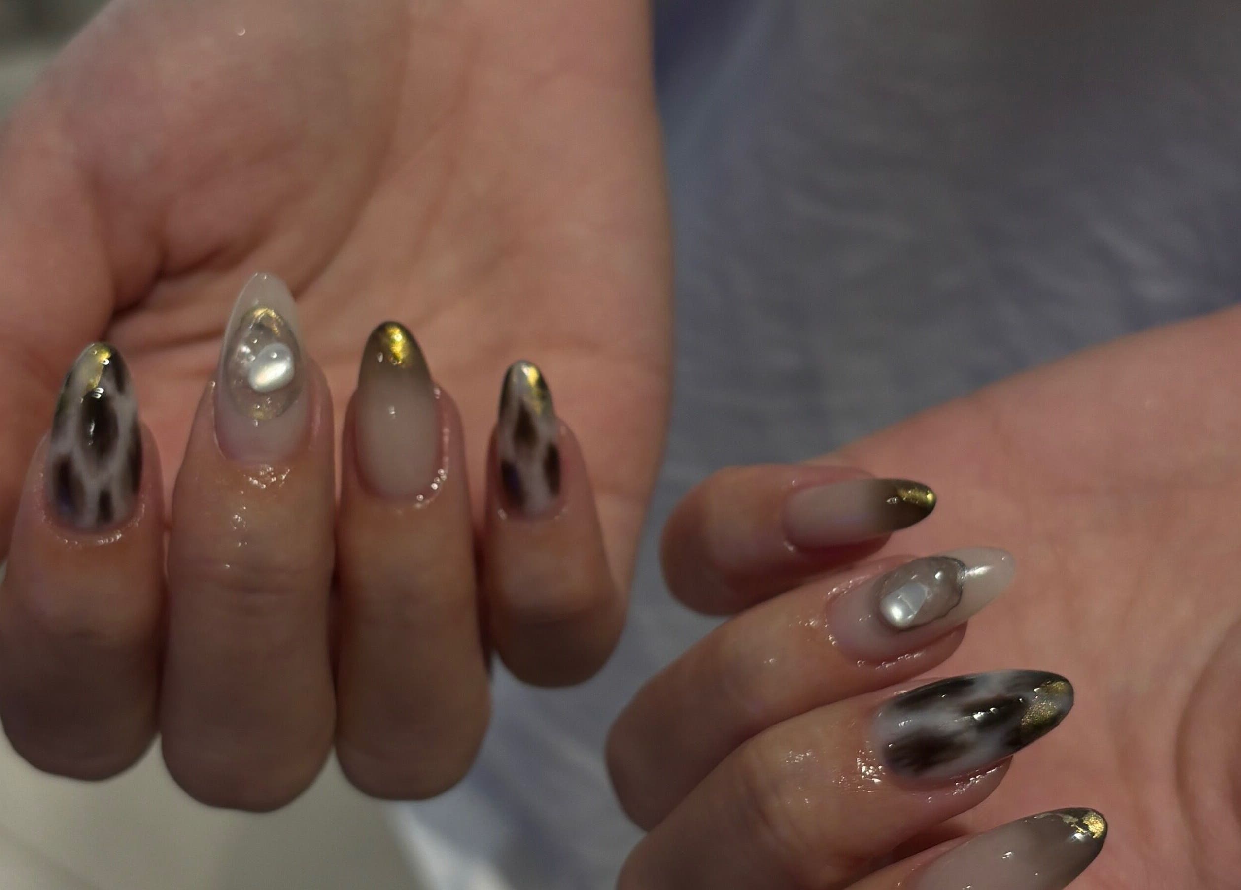 Elegant nail art at Katiedonails, Vancouver, British Columbia, CA, featuring gold accents and pearl designs.