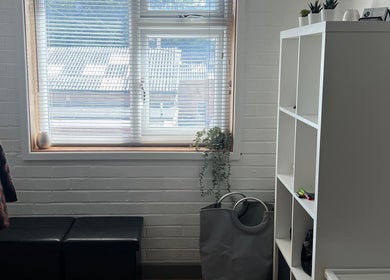 Bright and cozy interior of LP Sports Therapy in Burbage, England, GB, featuring a window and organized shelving.
