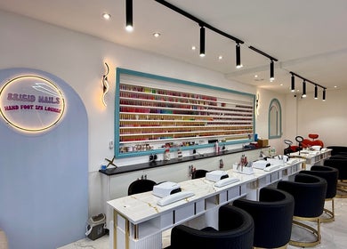 Elegant interior of Brigid Nails, Monaghan, County Monaghan, IE, showcasing plush seating and nail polish display.