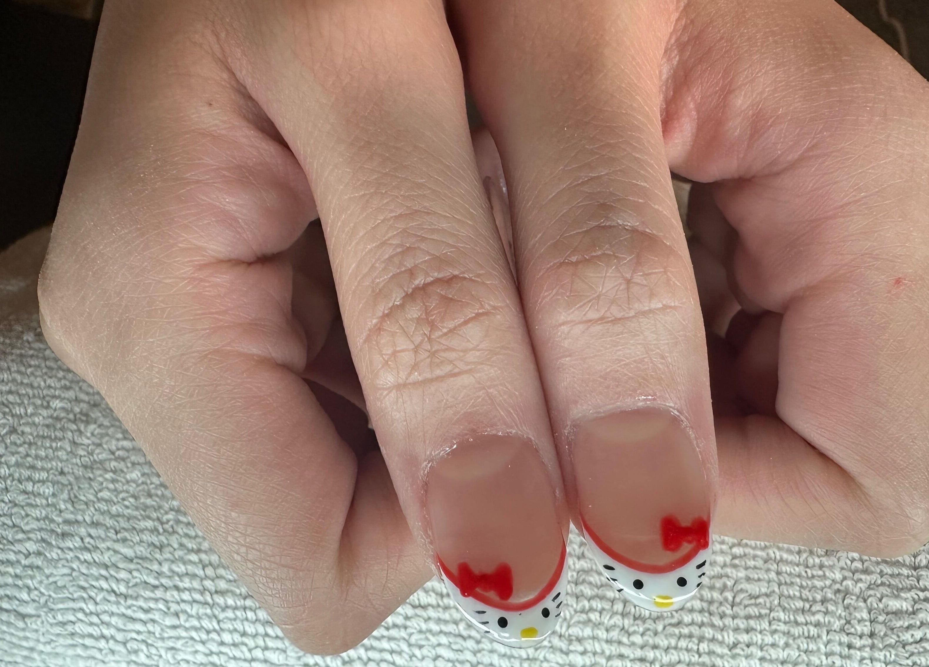 Hello Kitty-themed nail art at Tatabeautyhouse, Canterbury, England, GB.