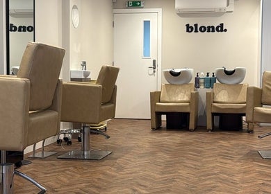 Modern salon interior at Natasha Ellen Hair, Sarisbury Green, England, GB, featuring sleek chairs and washing stations.