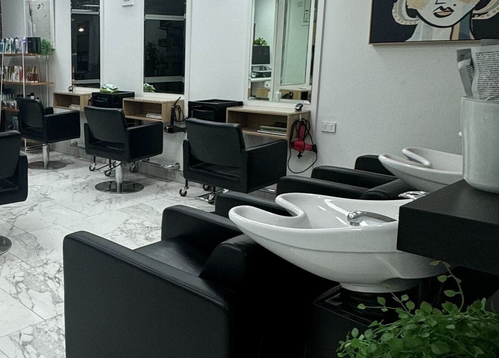 Modern interior of Revelations In Hair Design, Wellington Point, Queensland, AU, featuring chic styling chairs.