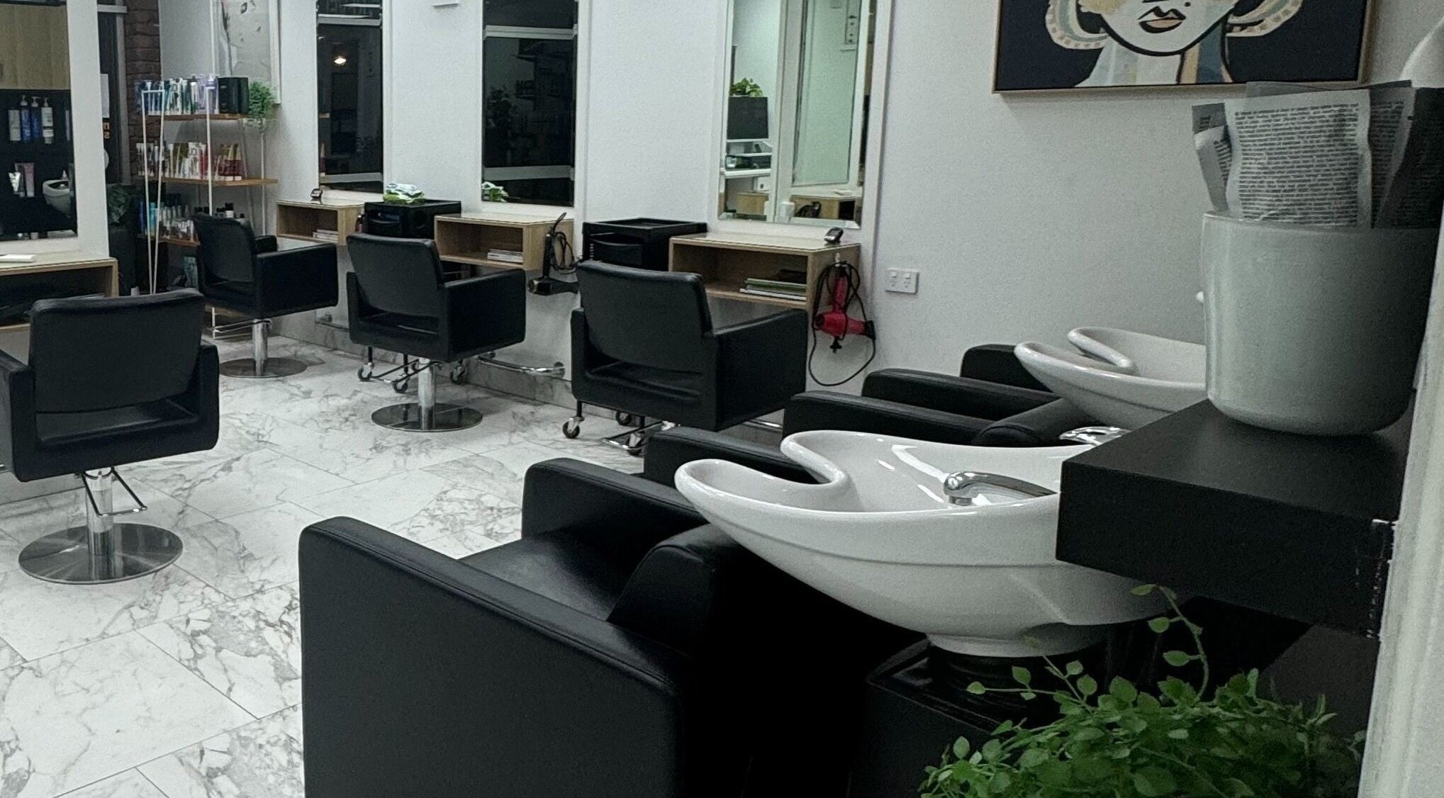 Modern interior of Revelations In Hair Design, Wellington Point, Queensland, AU, featuring chic styling chairs.