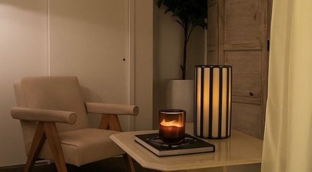 Cozy lounge at Noble Men's Spa, New York, featuring a plush chair and ambient lighting.