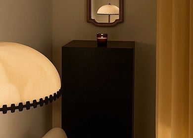 Elegant corner at Noble Men‘s Spa, New York with a warm lamp reflecting in a mirror. Perfect relaxation setting.