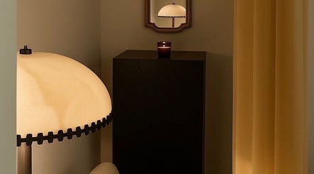 Elegant lamp and candlelight at Noble Men’s Spa, New York, US, creating a tranquil atmosphere.