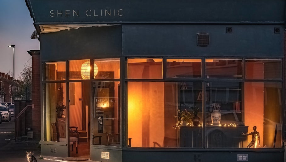 Exterior view of Soma Body Studio in Manchester, England, GB, warmly illuminated at dusk.