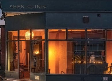 Exterior view of Soma Body Studio in Manchester, England, GB, warmly illuminated at dusk.
