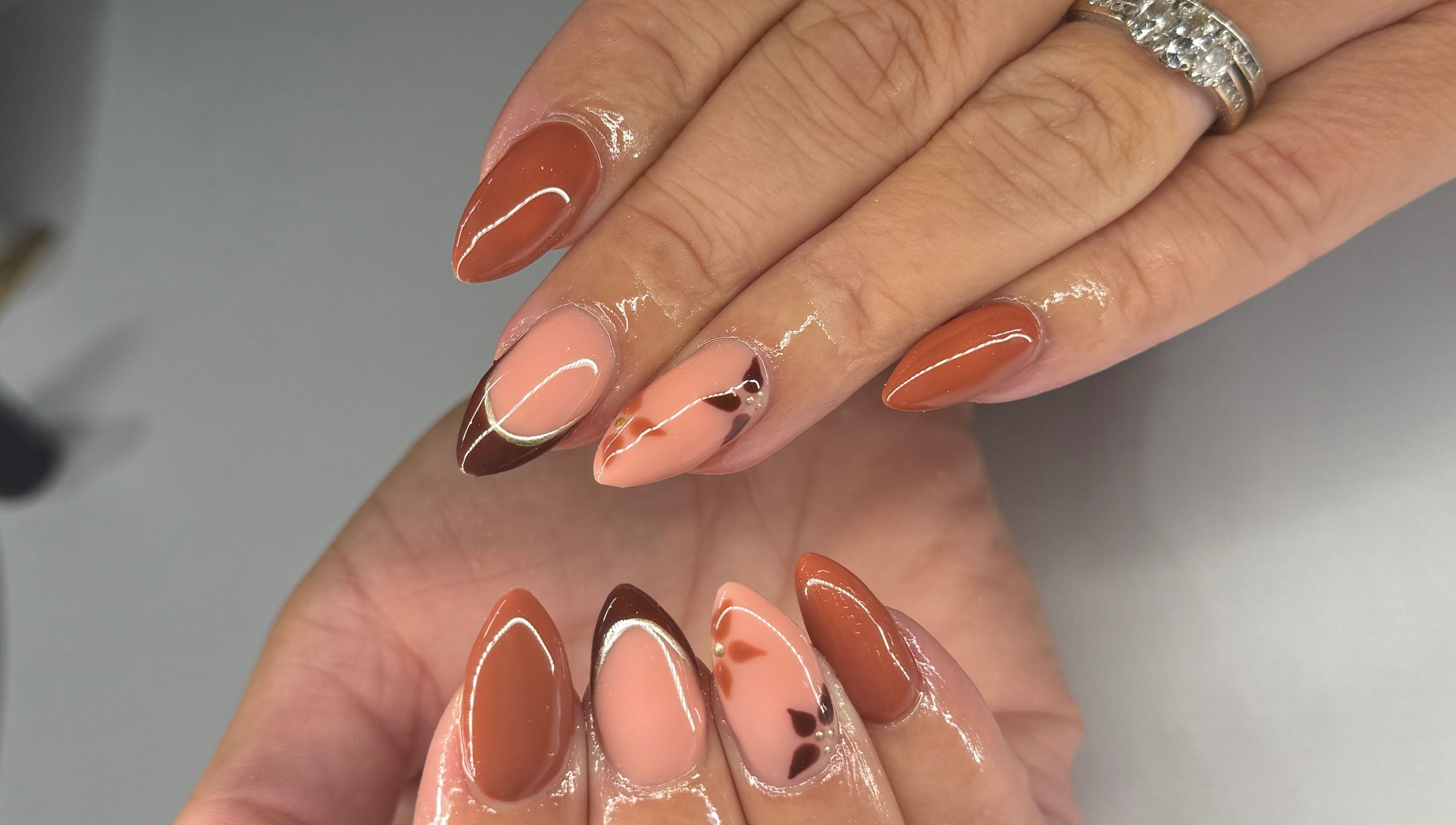 Elegant autumn-themed nail art at Nikki Nails, Llansamlet, Wales, GB.