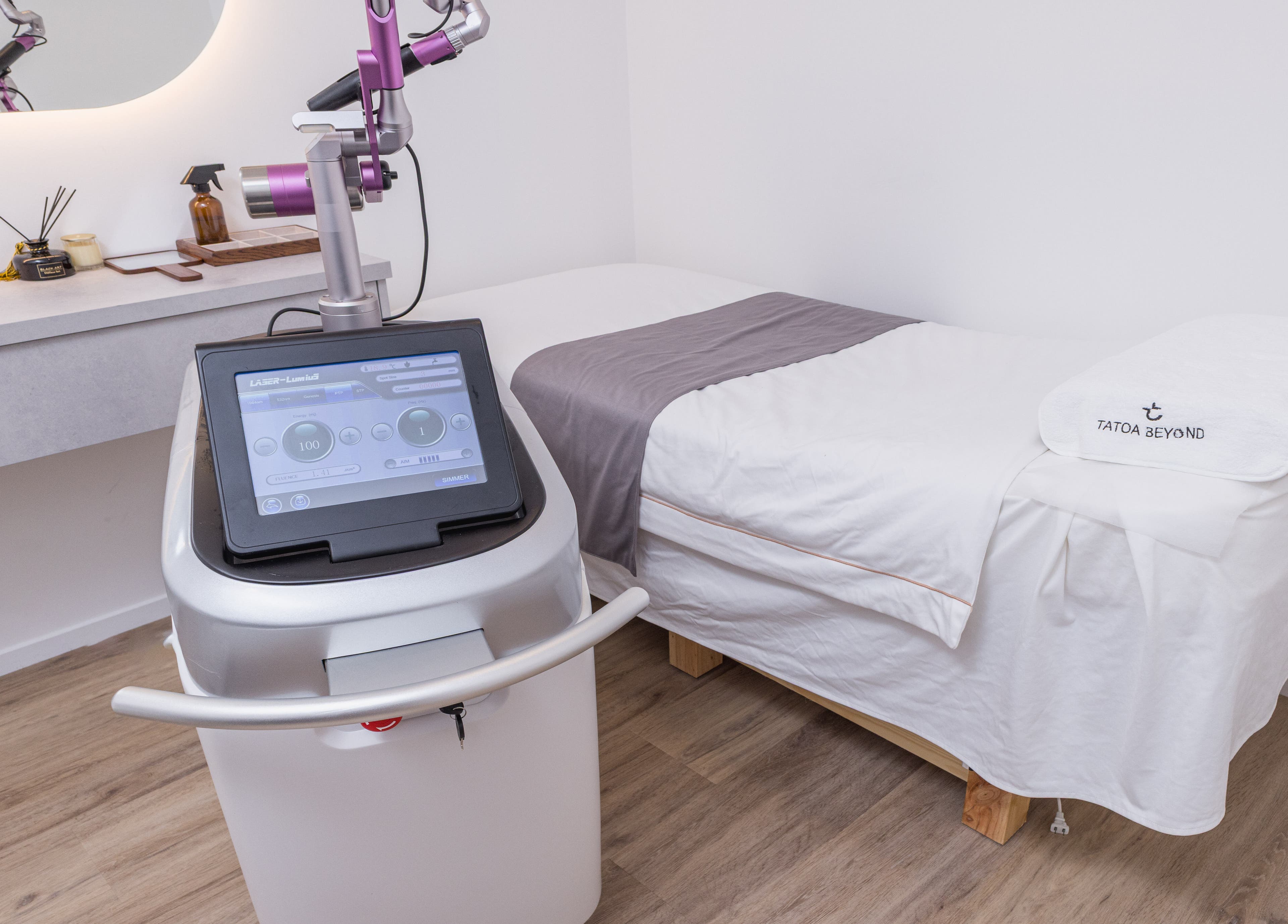 Modern treatment room at Tatoa Beyond (Hamilton), featuring a laser machine and a plush bed in Hamilton, Waikato Region, NZ.