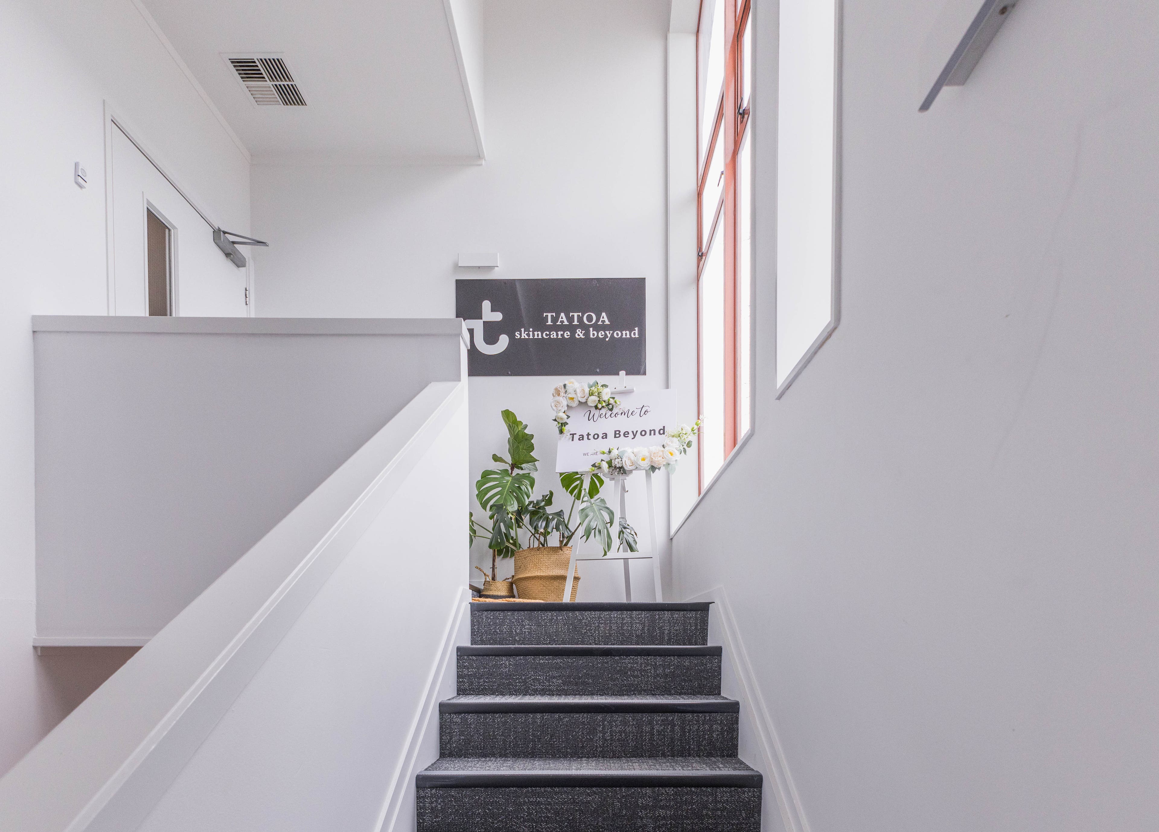 Entrance staircase to Tatoa Beyond in Hamilton, Waikato Region, NZ with welcoming floral display.