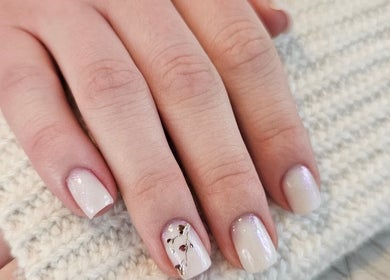 Elegant nail design at Iconic Nails Lounge, Vernon, British Columbia, CA, featuring white polish with gold accents.