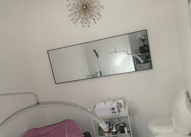 Elegant treatment room at Belleza Glam Studio in South Gate, California, US, with spa bed and modern decor.