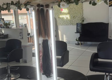 Elegant interior of Belleza Glam Studio in South Gate, California, US with styling chairs and hair extensions.
