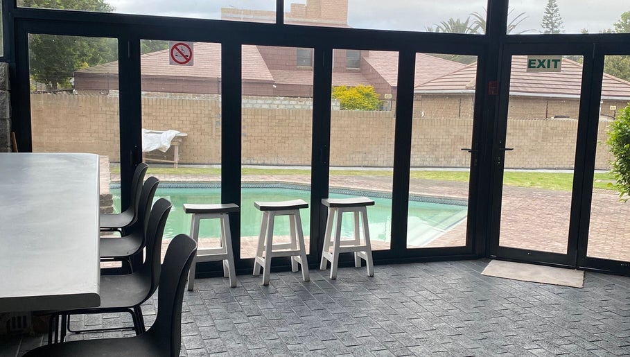 Indoor seating with pool view at Braids by Zonke, Gqeberha, Eastern Cape, ZA.