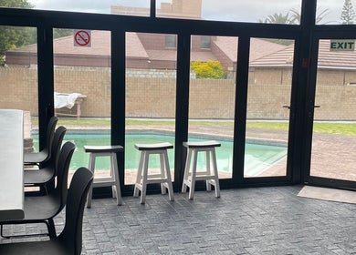 Indoor seating with pool view at Braids by Zonke, Gqeberha, Eastern Cape, ZA.