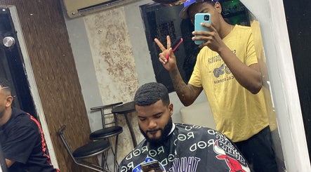 Barber styling client's hair at The Feoh barbershop in Santo Domingo Este, Santo Domingo, DO.