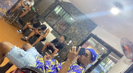 Relaxed atmosphere at The Feoh barbershop, Santo Domingo Este, Santo Domingo, DO, with clients waiting.