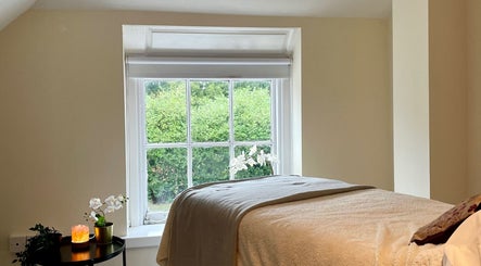 Tranquil treatment room at Malia Organic Therapies, Christchurch, Hampshire Dorset, GB, featuring soft lighting.