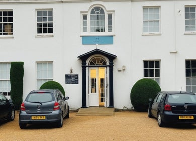 Entrance of Louisa Sales Malia Organics in Christchurch, Hampshire Dorset, GB with parked cars.