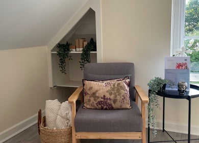 Relaxing chair setup in Louisa Sales Malia Organics, Christchurch, Hampshire, GB with a view of greenery.