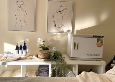 Tranquil spa room at Louisa Sales Malia Organics, Christchurch, Hampshire, with art and towel warmer.