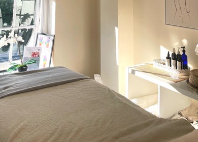 Tranquil treatment room at Louisa Sales Malia Organics, Christchurch, Hampshire, GB, with natural light and decor.