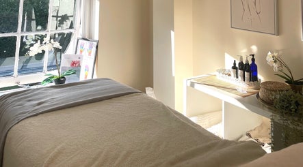 Tranquil treatment room at Louisa Sales Malia Organics, Christchurch, Hampshire, GB, with natural light and decor.