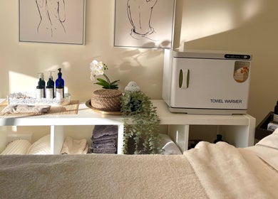 Relaxing treatment room at Louisa Sales Malia Organics, Christchurch, Hampshire, GB, featuring a towel warmer.
