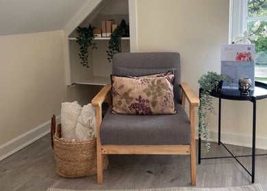 Relaxing corner at The Natural Skin Therapist, Christchurch, Hampshire, GB with a chair and decor.
