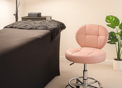 Relaxing treatment room at LuxeLine Aesthetics, Woodford Green, England, GB, featuring a plush chair and cozy decor.