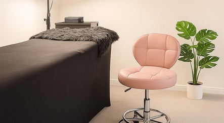 Relaxing treatment room at LuxeLine Aesthetics, Woodford Green, England, GB, featuring a plush chair and cozy decor.