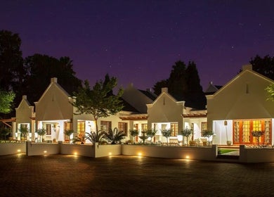 Peau Aesthetics venue in Germiston, Gauteng, ZA lit up beautifully at night under a starry sky.