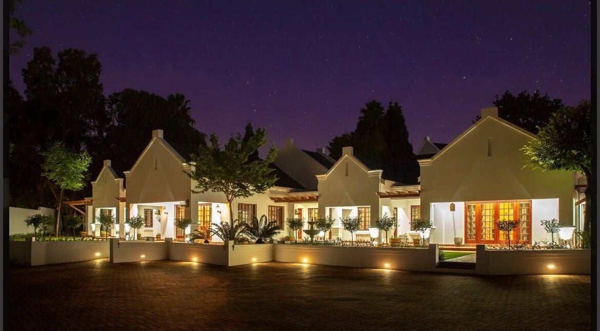 Peau Aesthetics venue in Germiston, Gauteng, ZA lit up beautifully at night under a starry sky.