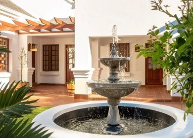 Peaceful courtyard with fountain at Peau Aesthetics, Germiston, Gauteng, ZA offering a serene retreat.