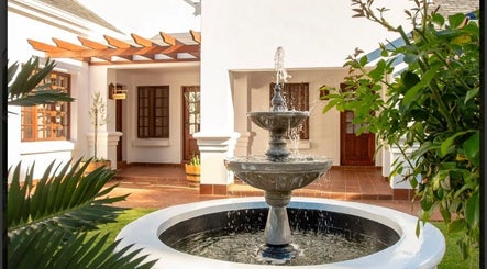 Peaceful courtyard with fountain at Peau Aesthetics, Germiston, Gauteng, ZA offering a serene retreat.