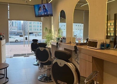 Chic interior of Black Oak Gents Salon in Dubai, Dubai, AE, featuring stylish barber chairs and modern decor.