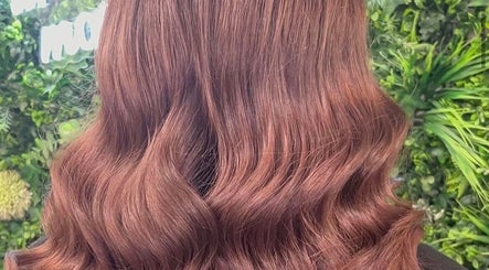 Elegant wavy brown hairstyle by GH Hairdressing, showcasing rich color in Heswall, England, GB.
