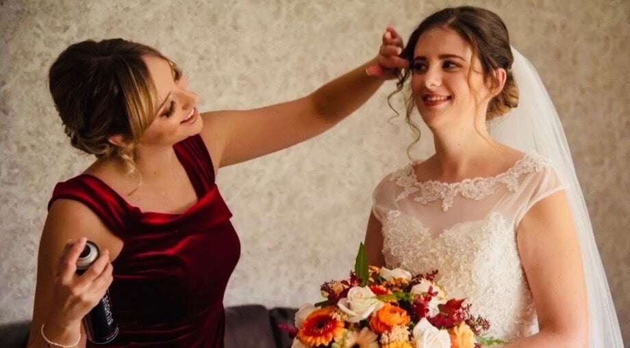 Stylist at GH Hairdressing in Heswall, England perfecting a bride's hair on her wedding day.