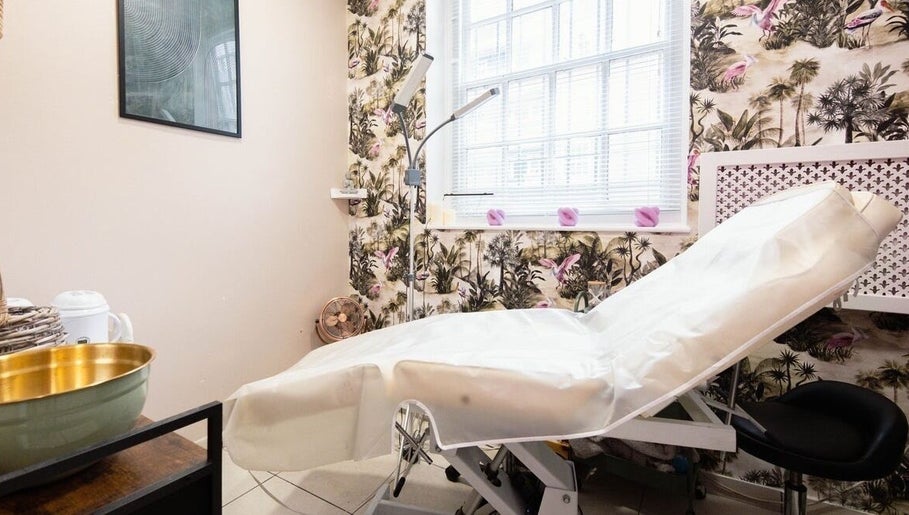Cozy treatment room at Herbal Beauty Studio, London, England, GB, featuring tropical decor and modern equipment.