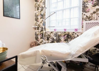 Cozy treatment room at Herbal Beauty Studio, London, England, GB, featuring tropical decor and modern equipment.