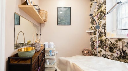 Cozy treatment room at Herbal Beauty Studio, London, England, GB with warm decor and relaxing ambiance.