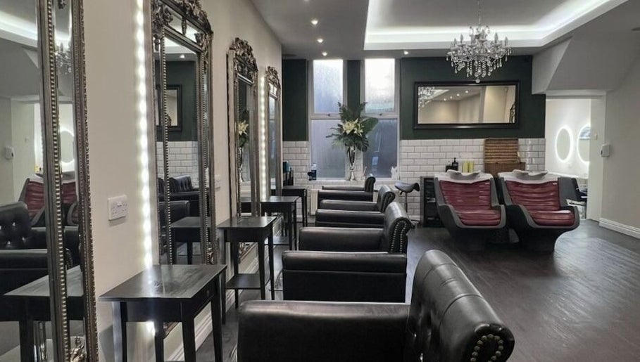 Chic interior of Newcastle Hair Company in Newcastle upon Tyne, showcasing plush chairs and ornate mirrors.