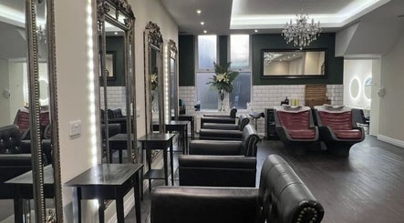 Chic interior of Newcastle Hair Company in Newcastle upon Tyne, showcasing plush chairs and ornate mirrors.