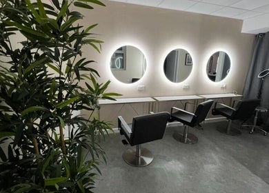 Modern salon chairs and round mirrors at Newcastle Hair Company, Newcastle upon Tyne, England, GB.