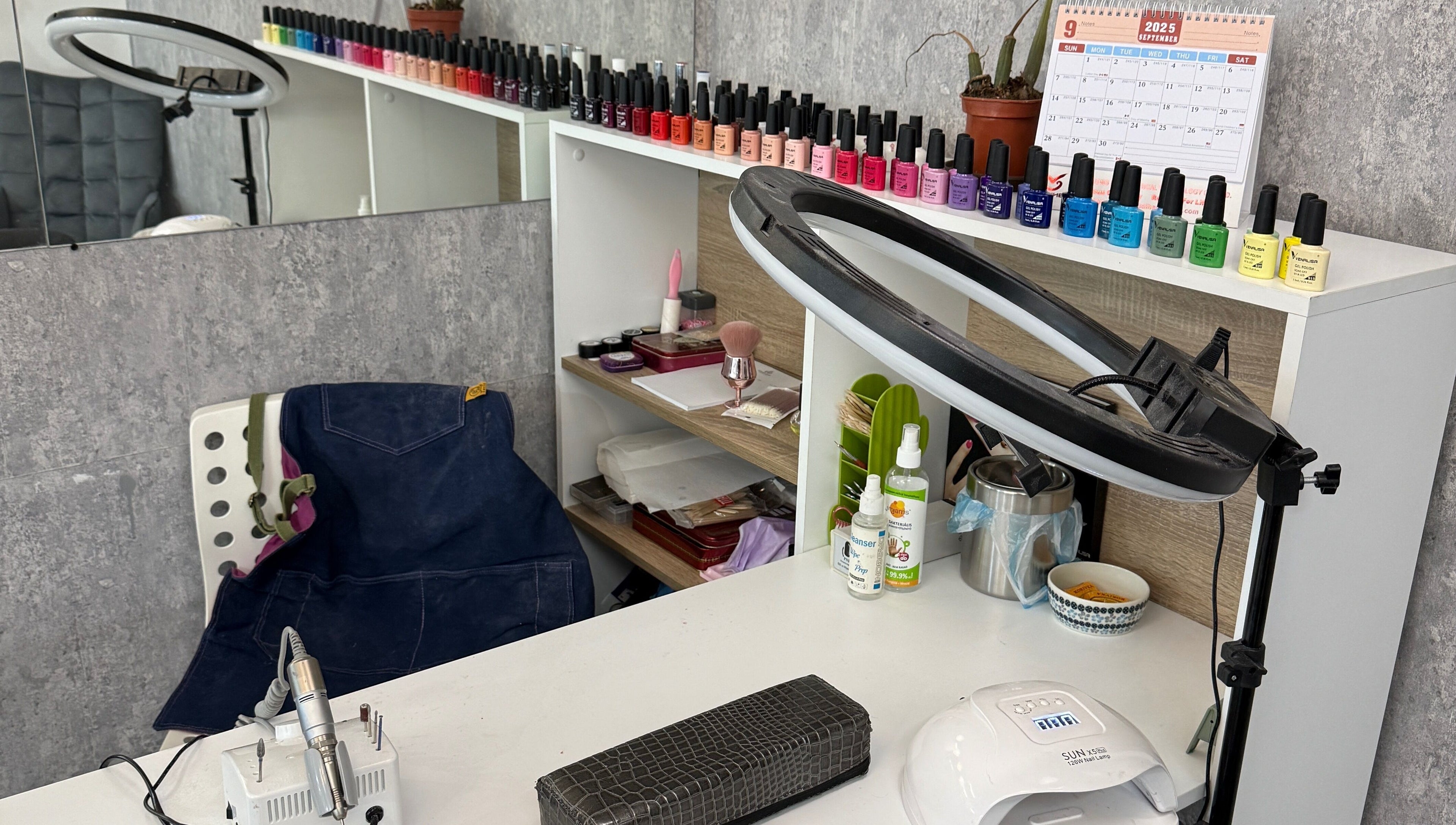 Nail polish station at Arya Beauty Salon, Budapest, Magyar, HU, featuring colorful polish and tools.