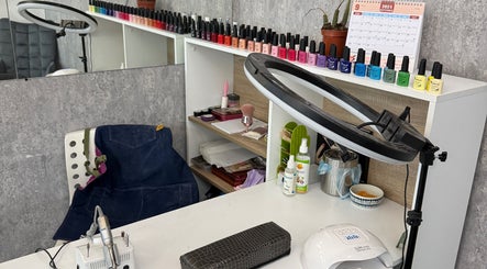 Nail polish station at Arya Beauty Salon, Budapest, Magyar, HU, featuring colorful polish and tools.