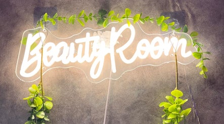 Illuminated 'Beauty Room' sign with greenery at LadamsNails, Ottawa, Ontario, CA.