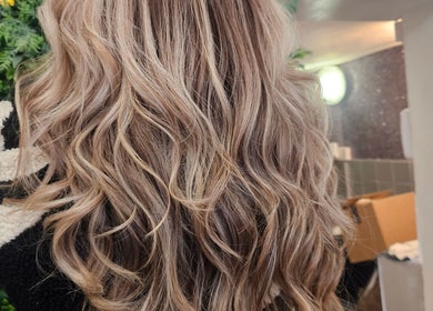 Glossy curls styled at Hair By Suzannee, Heswall, England, GB. Showcasing salon's expert hairstyling.