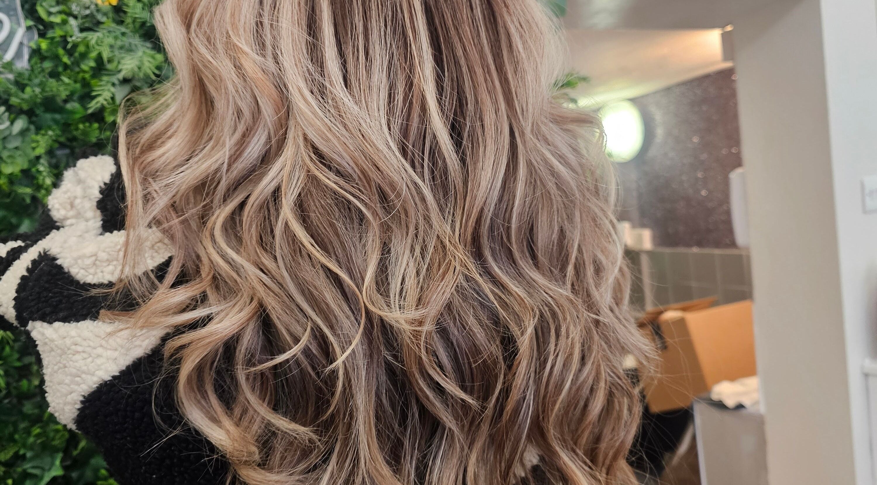 Glossy curls styled at Hair By Suzannee, Heswall, England, GB. Showcasing salon's expert hairstyling.